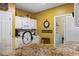 Bright kitchen features white cabinetry, a granite countertop, and a view into the laundry room at 5070 Windsor Green Way # 204, Myrtle Beach, SC 29579