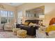 Comfortable living room featuring a recliner, sofa, ottomans, large window and a decorative mirror at 5070 Windsor Green Way # 204, Myrtle Beach, SC 29579