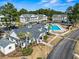 Aerial view of community clubhouse and pool area surrounded by lush landscaping and palm trees at 5070 Windsor Green Way # 204, Myrtle Beach, SC 29579