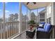 Inviting screened porch with lake view seating area, providing a cozy spot to relax and take in the scenery at 5070 Windsor Green Way # 204, Myrtle Beach, SC 29579