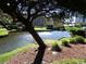 Peaceful view of a pond with a fountain, trees, and landscaping at 5905 S Kings Hwy. # 1801-C, Myrtle Beach, SC 29575