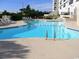 A large outdoor swimming pool with lounge chairs and building in the background at 5905 S Kings Hwy. # 1801-C, Myrtle Beach, SC 29575