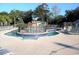 Community splash pad and pool area surrounded by lounge chairs and trees at 5905 S Kings Hwy. # 1801-C, Myrtle Beach, SC 29575