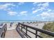 Beach access with ocean views, blue skies and beach umbrellas at 5905 S Kings Hwy. # 235B, Myrtle Beach, SC 29575