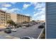 Parking area with parked vehicles, palm trees, and view of a nearby beach and ocean at 5905 S Kings Hwy. # 235B, Myrtle Beach, SC 29575