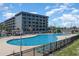 Large community pool with a multi-story condominium in the background at 5905 S Kings Hwy. # 235B, Myrtle Beach, SC 29575