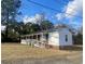 Side view of brick home showing long, covered porch with ramp at 611 E Ashland St., Andrews, SC 29510