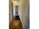 Hallway with hardwood flooring and neutral walls, connecting to various rooms in the home at 611 E Ashland St., Andrews, SC 29510