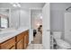 Bright bathroom featuring a double vanity, tiled floor, and a glimpse into the bedroom at 624-B Seabreeze Dr., Garden City Beach, SC 29576