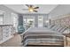 Comfortable bedroom featuring a king-size bed, neutral carpet, a ceiling fan, and access to the balcony at 624-B Seabreeze Dr., Garden City Beach, SC 29576