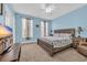 Serene bedroom with a coastal theme, including a wooden bed frame and two windows with patterned curtains at 624-B Seabreeze Dr., Garden City Beach, SC 29576