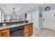 Kitchen with wood cabinetry offering easy access to both the front door and a comfortable living area at 624-B Seabreeze Dr., Garden City Beach, SC 29576