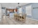 Bright eat-in kitchen featuring tile floors, light blue walls, and a dining table with seating for six at 624-B Seabreeze Dr., Garden City Beach, SC 29576