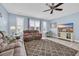 Comfortable living room with a ceiling fan, a large window, and a cozy seating area with a patterned rug at 624-B Seabreeze Dr., Garden City Beach, SC 29576