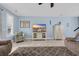 Living room featuring a ceiling fan, stylish furnishings, and a cabinet for storing electronics and displaying decor at 624-B Seabreeze Dr., Garden City Beach, SC 29576