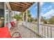 Relaxing porch featuring outdoor seating, and views of the neighborhood street and lush palm trees at 624-B Seabreeze Dr., Garden City Beach, SC 29576