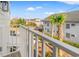 Balcony view showcasing charming neighborhood with palm trees under clear blue skies at 6606 Wildwood Trail # D, Myrtle Beach, SC 29572