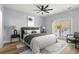 Bright bedroom featuring a ceiling fan, a sliding glass door, and modern decor at 6606 Wildwood Trail # D, Myrtle Beach, SC 29572