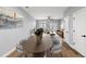 Open-concept dining area adjacent to the living room with hardwood floors and neutral colors throughout the space at 6606 Wildwood Trail # D, Myrtle Beach, SC 29572