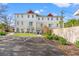 New townhome features a white exterior, well-manicured landscaping, and a private outdoor space with parking at 6606 Wildwood Trail # D, Myrtle Beach, SC 29572