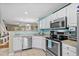 Well-lit kitchen featuring stainless steel appliances and crisp, white cabinetry at 677 Wilshire Ln. # 677, Murrells Inlet, SC 29576