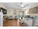 Spacious living room featuring stylish seating, a ceiling fan, and a sliding glass door to an outdoor patio at 677 Wilshire Ln. # 677, Murrells Inlet, SC 29576