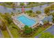 Aerial shot of community pool with a surrounding patio, landscaping, and access to a waterway at 677 Wilshire Ln. # 677, Murrells Inlet, SC 29576