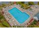 Aerial view of large community pool featuring various seating areas, landscaping, and community water access at 677 Wilshire Ln. # 677, Murrells Inlet, SC 29576