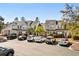 Street view of townhomes featuring ample parking and mature trees at 677 Wilshire Ln. # 677, Murrells Inlet, SC 29576