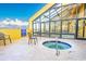 Outdoor jacuzzi tub with metal safety rails and seating and glass enclosed area with chairs visible at 6900 N Ocean Blvd. # 1536, Myrtle Beach, SC 29572