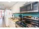 Galley kitchen featuring granite countertops, stainless steel appliances, and a colorful backsplash at 6900 N Ocean Blvd. # 1536, Myrtle Beach, SC 29572