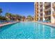 An expansive swimming pool is surrounded by lounge chairs with a colorful splash pad in the background at 6900 N Ocean Blvd. # 1536, Myrtle Beach, SC 29572