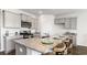 Inviting kitchen island with granite counters, a stainless sink, and barstool seating at 8058 Bear Claw Ct., Conway, SC 29526