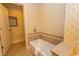 Cozy bathroom featuring a standard tub with tiled surround, alongside a toilet and storage area at 8121 Amalfi Pl. # 4-702, Myrtle Beach, SC 29572