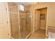 Modern bathroom featuring a glass-enclosed shower with tiled walls and a door to a separate room at 8121 Amalfi Pl. # 4-702, Myrtle Beach, SC 29572