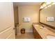 Bathroom featuring a double sink vanity with granite countertops, decorative mirror, and storage at 8121 Amalfi Pl. # 4-702, Myrtle Beach, SC 29572