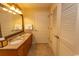 Bathroom featuring double sinks with granite countertops, wooden cabinets, and a large mirror at 8121 Amalfi Pl. # 4-702, Myrtle Beach, SC 29572