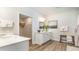 Bright bathroom featuring a double sink vanity, wooden floors, walk in shower and an open closet space at 815 Ireland Dr., Longs, SC 29568