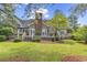 Expansive backyard featuring a deck, mature landscaping and a brick chimney at 8234 Timber Ridge Rd., Conway, SC 29526