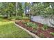 Well manicured landscaping with trees and a brick trimmed garden at 8234 Timber Ridge Rd., Conway, SC 29526