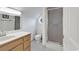 Bright bathroom featuring a modern vanity, toilet, shower, and an octagonal window for plenty of natural light at 8234 Timber Ridge Rd., Conway, SC 29526