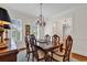 Formal dining room with chandelier, shuttered windows, and elegant furniture, perfect for entertaining guests at 8234 Timber Ridge Rd., Conway, SC 29526