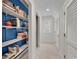 Charming hallway with built-in bookshelves painted in a vibrant blue, offering ample storage and style at 8234 Timber Ridge Rd., Conway, SC 29526