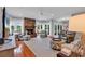 Spacious living room featuring a brick fireplace, hardwood floors, and lots of natural light from the many windows at 8234 Timber Ridge Rd., Conway, SC 29526