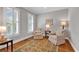 Cozy sitting room with hardwood floors, neutral walls, shuttered windows, and comfortable seating at 8234 Timber Ridge Rd., Conway, SC 29526