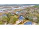 Aerial view of coastal homes nestled among trees, offering views of the water at 830 Channel Cat Cove, Murrells Inlet, SC 29576