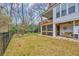 Expansive backyard view with lush grass, putting green, and a screened porch, ideal for outdoor living at 830 Channel Cat Cove, Murrells Inlet, SC 29576