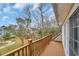 Cozy wooden balcony overlooking a leafy backyard and neighborhood at 830 Channel Cat Cove, Murrells Inlet, SC 29576