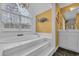 Bright bathroom featuring an oversized tub with steps and a large window at 830 Channel Cat Cove, Murrells Inlet, SC 29576