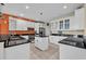 Modern kitchen featuring white cabinets, black countertops, and stainless steel appliances at 830 Channel Cat Cove, Murrells Inlet, SC 29576